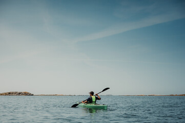 person kayaking in the sea