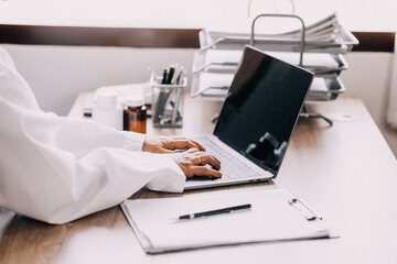 Online training. Young Latin American girl student doctor studies online at home from laptop