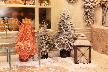 Xmas festive street with snow, bench and baking in showcase near a cafe bakery. Christmas decor:...