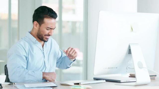 Successful and excited trader celebrating victory with a happy dance after reading good news about an exciting deal or bonus. Business man cheering with joy while working on a computer in an office.