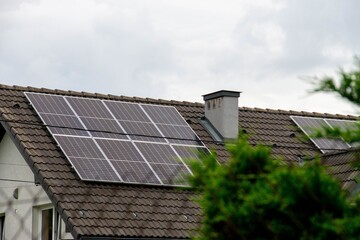 Historic farm house with modern solar panels on roof and wall