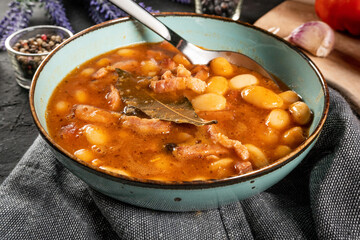 Beans with tomato sauce, bacon and sausage.