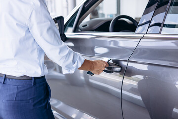 Woman using mobile phone to open her car