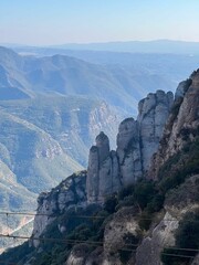 Fototapeta na wymiar Montserrat is a majestic multi-peaked mountain range located in Catalonia, Spain