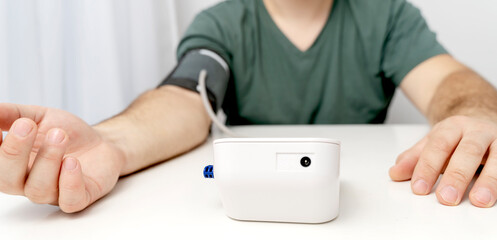 a man measures blood pressure with a tonometer