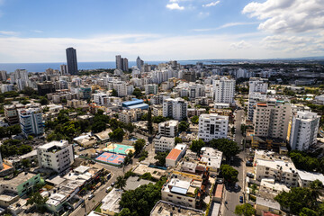 Fototapeta premium Beautiful aerial view of the city of Santo Domingo - Dominican Republic with is Parks, buildings, suburbs ,turquoise Caribbean ocean, parks and malecon
