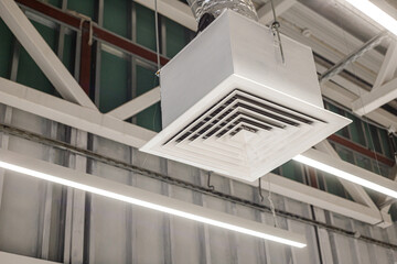 Obraz premium Square grid with supply ventilation duct in commercial building. Industrial ventilation system