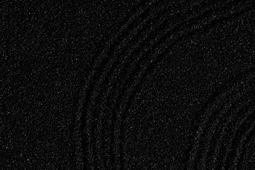 Zen garden, Japanese garden with art line pattern on black sand background,Top Sand Nature texture surface with wave lines pattern,Background banner for Harmony,Meditation,Feng Shui,Zen like concept