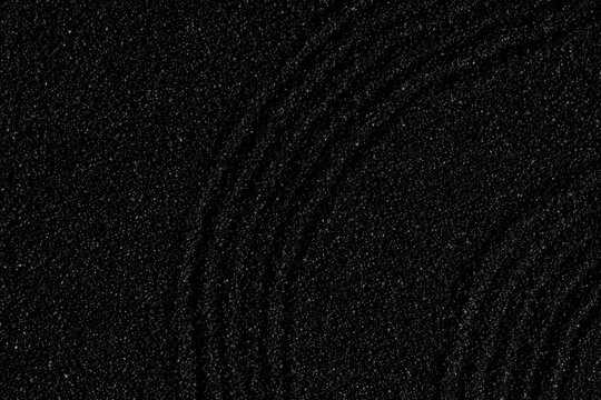 Zen garden, Japanese garden with art line pattern on black sand background,Top Sand Nature texture surface with wave lines pattern,Background banner for Harmony,Meditation,Feng Shui,Zen like concept