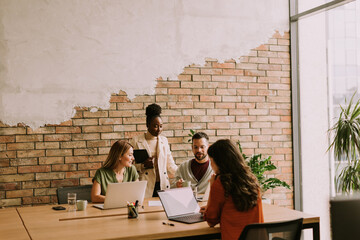 Young multiethnic startup team working in the rustic office