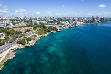 Beautiful aerial view of the city of Santo Domingo - Dominican Republic with is Parks, buildings, suburbs ,turquoise Caribbean ocean, parks and malecon - obrazy, fototapety, plakaty