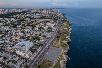 Obraz premium Beautiful aerial view of the city of Santo Domingo - Dominican Republic with is Parks, buildings, suburbs ,turquoise Caribbean ocean, parks and malecon