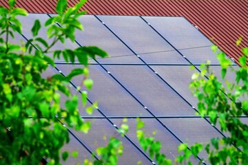 Historic farm house with modern solar panels on roof and wall