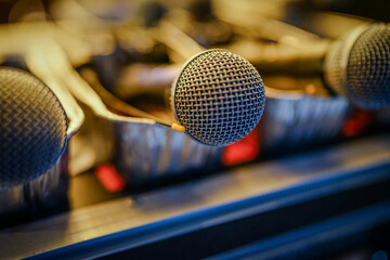 Closeup of Microphones Sitting on a Desk in Metal Tins