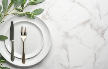 Stylish setting with cutlery and eucalyptus leaves on white marble table