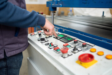 hand worker on control panel