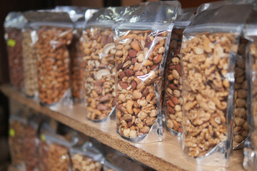many mixed nuts in a plastic packet on shelf 