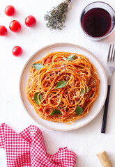 Spaghetti pasta with tomato sauce, basil and Parmesan cheese. Italian cuisine. Vegetarian food.