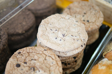 sweet cookies in a transparent jar display for sale at cafe 