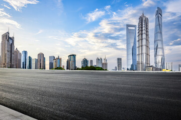 Fototapeta na wymiar Asphalt road and city buildings skyline background in Shanghai