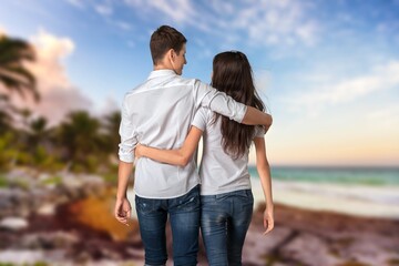 Happy couple walking on beach sand