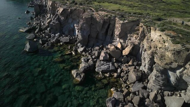 Rocky coast the southern part of the San Pietro island, cliffs of Colonne di Carloforte, small island near Sardinia, aerial view