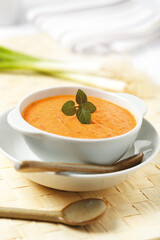 Red pepper sauce on a white bowl.