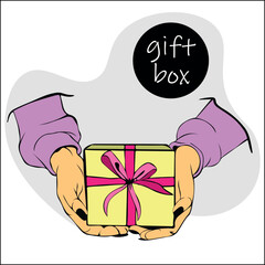 Female hands hold gift box with ribbon and bow. Concept of giving gifts and receiving surprise. Hands hold gift box made of yellow paper with bright pink bow made of satin ribbon.