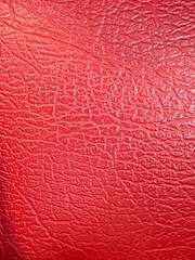 Closeup shot of a red leather surface.