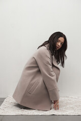Beautiful fashion girl posing in a stylish coat