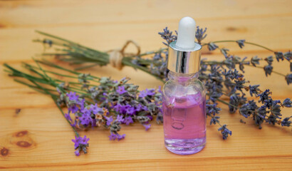 Obraz na płótnie Canvas lavender essential oil, on a wooden background. Selective focus.