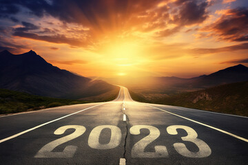 2023 End of Year Concept: '2023' Written on a Sunset Road with Mountain Backdrop. Beautiful evening Copy Space for text, banner or poster