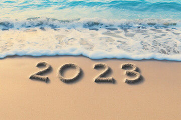 Fototapeta na wymiar New Year 2023: Numbers 2023 Written on Sandy Beach with Blue Ocean Wave in the Background and Copy Space for Text