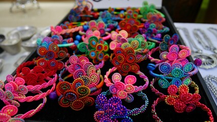 hand-made colorful Yunnan traditional flower bracelets - obrazy, fototapety, plakaty