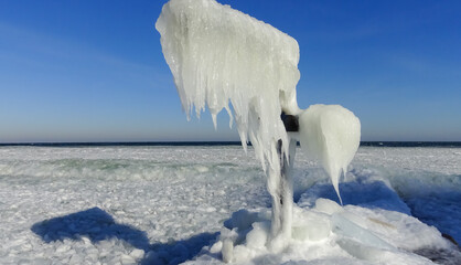 Frozen Black Sea, blocks of ice on the shore on the pier