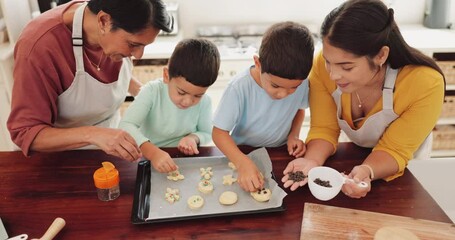 Baking, family and kitchen with kids and parents cooking cookies at home with food. Support, care and children with mom and grandmother together with teaching and helping in a house with support