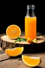 Vertical shot of a bottle of fresh orange juice on the table