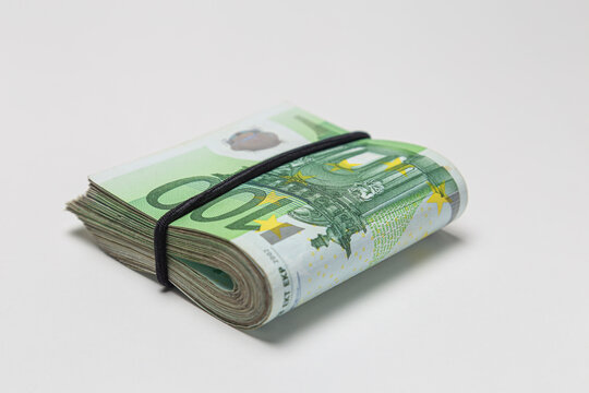 Bundle of 100 euro banknotes isolated on a white background.
