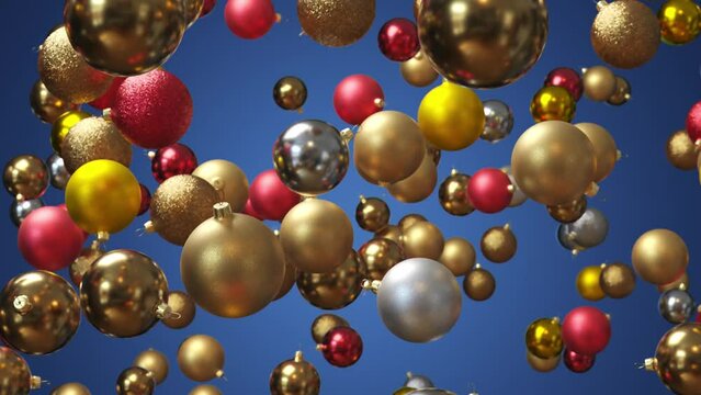 Super slow motion of flying christmas balls on colored background. 