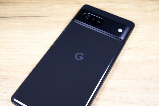KYIV, UKRAINE - October 03, 2023 :  Modern smartphone Google Pixel on wooden table background.