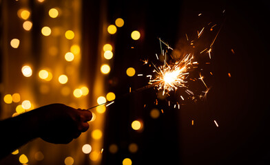 Hand holding sparkler and celebrating Diwali festival, Happy Diwali concept background