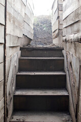 Fototapeta na wymiar Wooden stairs to the military dugout