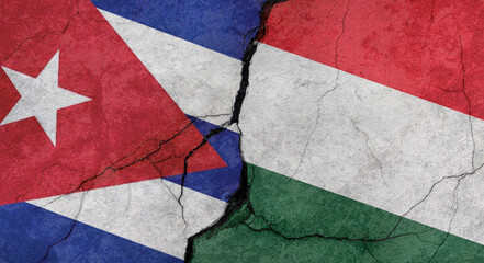 Flags of Cuba and Hungary, texture of concrete wall with cracks, grunge background, military conflict concept