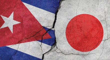 Naklejka premium Flags of Cuba and Japan, texture of concrete wall with cracks, grunge background, military conflict concept