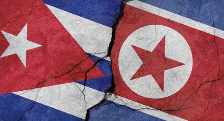 Cuba and North Korea flags, concrete wall texture with cracks, grunge background, military conflict concept