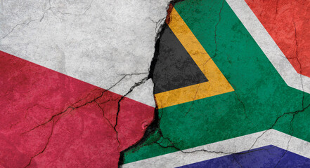 Poland and South Africa flags, concrete wall texture with cracks, grunge background, military conflict concept