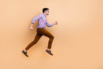 Full length profile side photo of positive nice man hurrying special sale offer looking empty space isolated on beige color background