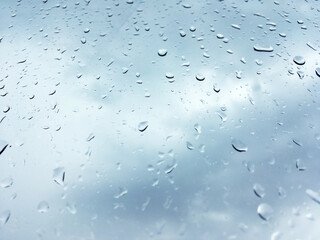 Rain water flows down from the glass. Abtrect image, water drops on the glass, rainy day on the glass.