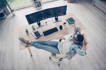 Full body photo upper view of young positive man relaxing finished successfully programming code...