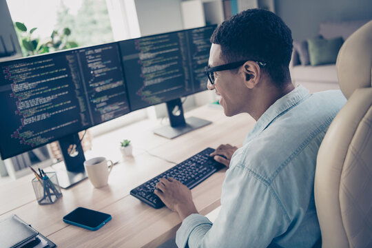 Side profile shot of busy man it startuper creating new nft collection coding computer typing keyboard in modern office workstation